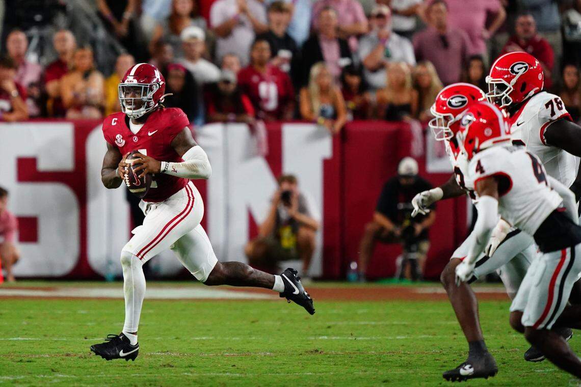 Sep 28, 2024; Tuscaloosa, Alabama, USA;  Alabama Crimson Tide quarterback Jalen Milroe (4) rolls out to throw against the Georgia Bulldogs during the fourth quarter at Bryant-Denny Stadium. Mandatory Credit: John David Mercer-Imagn Images