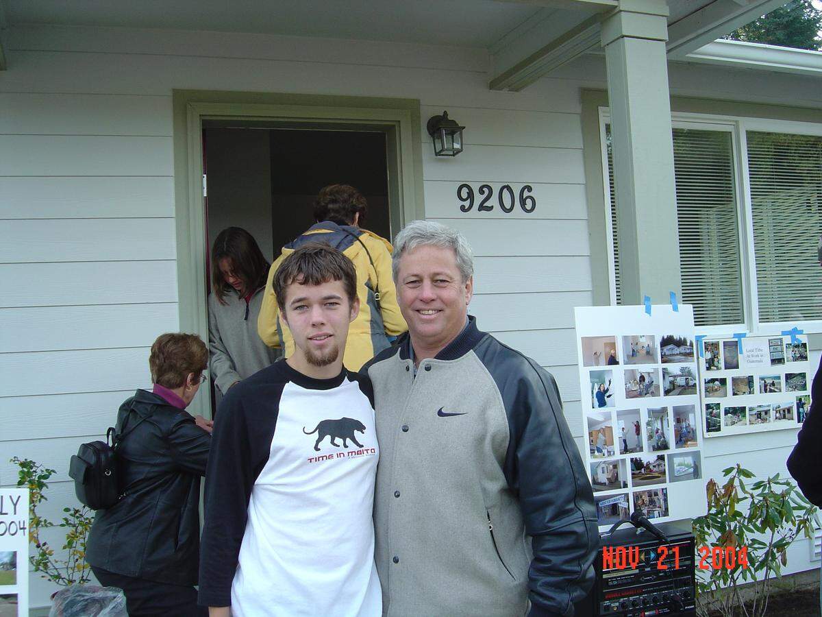 Rich Phillips (left) and his son, Richie Phillips, pose for a photo at the dedication of a Gig Harbor-area Habitat for Humanity home in 2004.