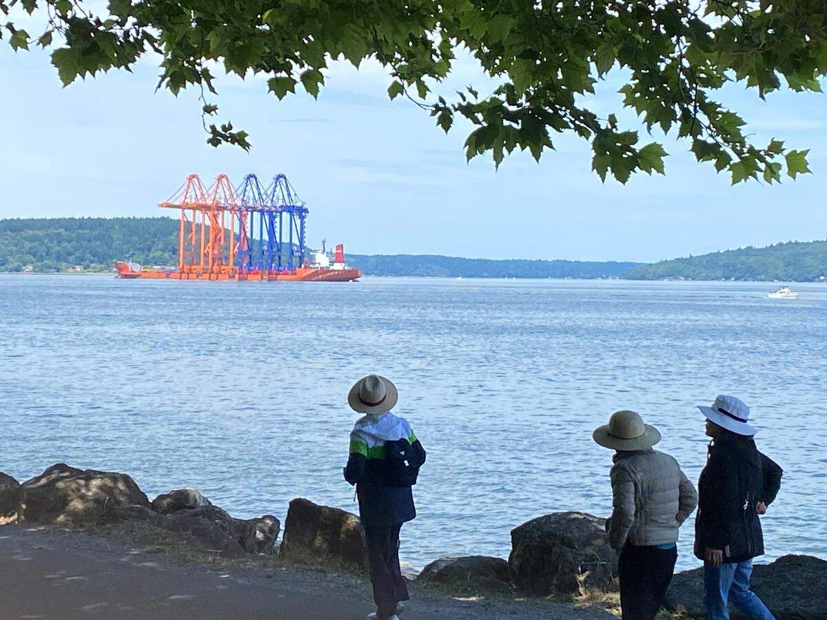 The Zhen Hua 23 is seen in 2019 sitting at anchor in Commencement Bay as seen from Ruston Way with four shipping cranes secured on its deck.