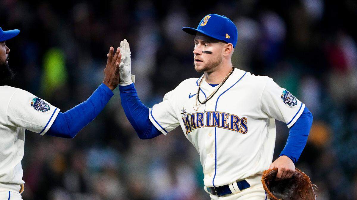 Seattle Mariners’ Jarred Kelenic, right, high-fives teammate Teoscar Hernandez, left, as they celebrate a 1-0 win over the Colorado Rockies in a baseball game, Sunday, April 16, 2023, in Seattle. Kelenic drove in the only run of the game, an RBI single in the sixth inning to score Ty France. (AP Photo/Lindsey Wasson)