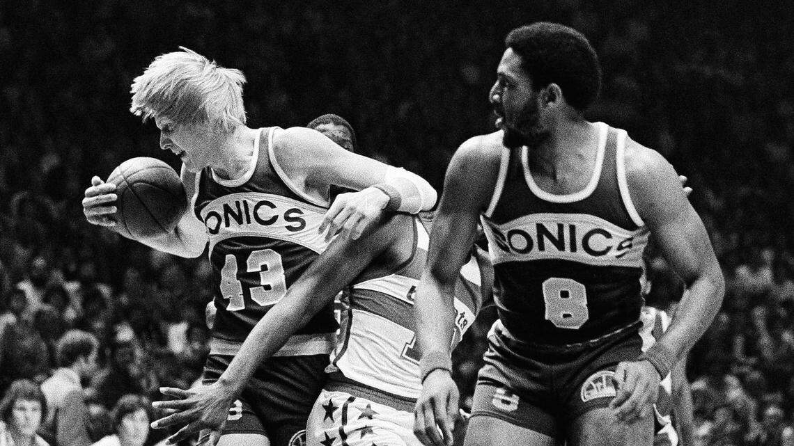 Seattle Supersonic Jack Sikma grabs a rebound under the Washington Bullet basket during first period action in Landover, Maryland at night on Thursday, May 24, 1979. Sonic Lonnie Shelton is at right with Bullet Elvin Hayes sandwiched in the middle. (AP Photo/Smith)