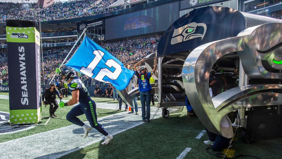 Seahawks linebacker and West Point cadet Jon Rhattigan leads the Seattle Seahawks onto the field to play the Tennessee Titans in an NFL football game at Lumen Field in Seattle, Wash., on Sunday, Sept. 19, 2021.