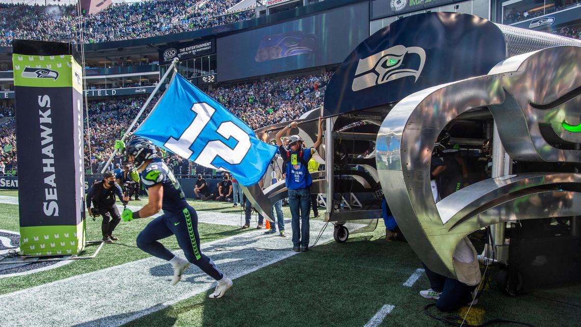 Seahawks linebacker and West Point cadet Jon Rhattigan leads the Seattle Seahawks onto the field to play the Tennessee Titans in an NFL football game at Lumen Field in Seattle, Wash., on Sunday, Sept. 19, 2021.