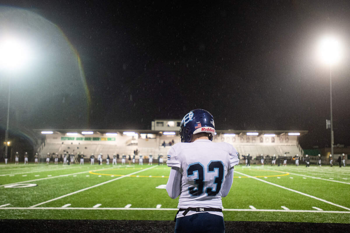 Gig Harbor’s Britton Born stands at the 50-yard line before the game. The Peninsula Seahawks played the Gig Harbor Tides in the annual Fishbowl rivalry game at Roy Anderson field in Purdy, Wash., on Friday, Feb. 19, 2021.