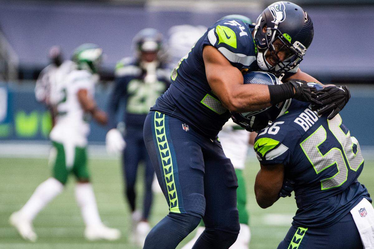 Seattle Seahawks linebacker Bobby Wagner and Seattle Seahawks linebacker Jordyn Brooks celebrate a sack by Brooks. The Seattle Seahawks played the New York Jets in a NFL football game at Lumen Field in Seattle, Wash., on Sunday, Dec. 13, 2020.