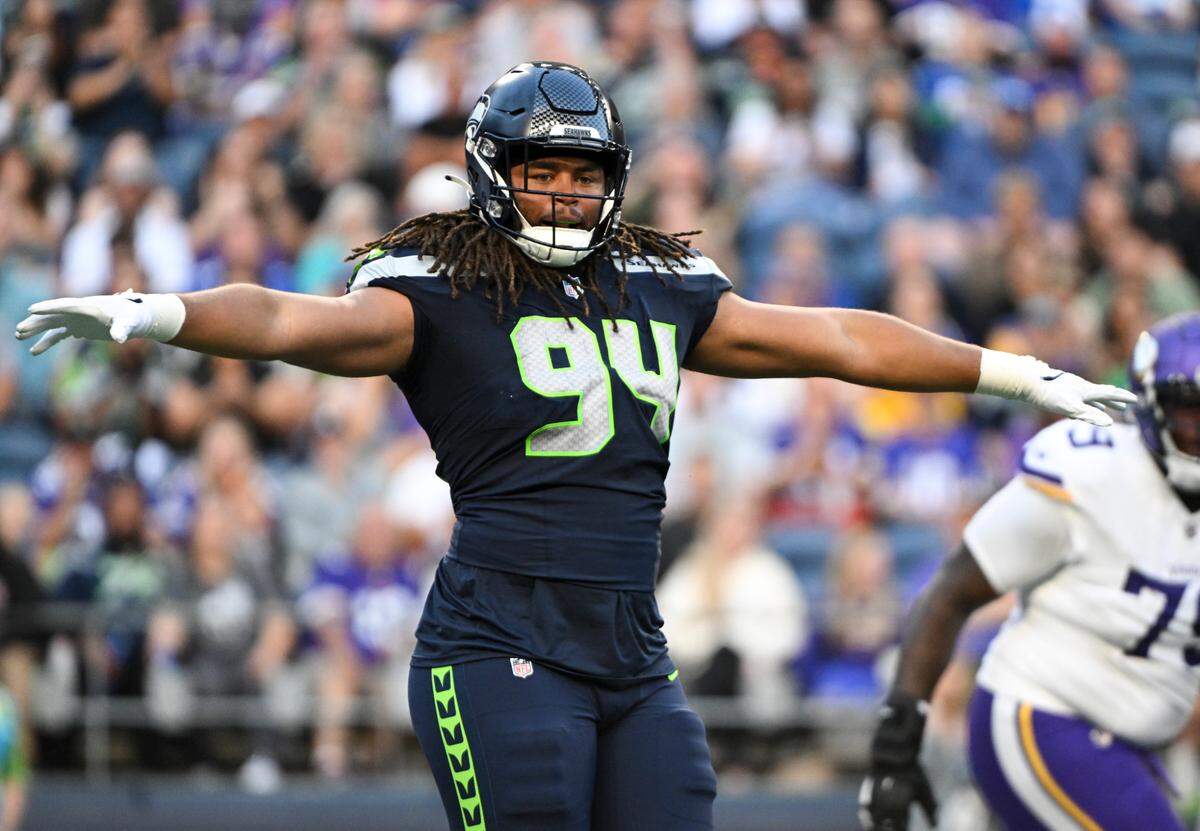 Seattle Seahawks defensive end Mike Morris (94) celebrates a hit on Minnesota Vikings quarterback Nick Mullens (12) during the first quarter of the preseason game at Lumen Field, Thursday, Aug. 10, 2023, in Seattle, Wash.