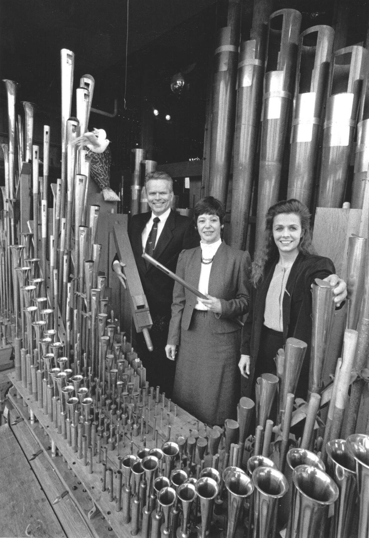 Pizza & Pipes restaurant owners Dick, left, and Margaret Daubert, center, with manager Rhonna Kramer, pose in 1988 with the pipes to the giant organ that made the Tacoma eatery famous.