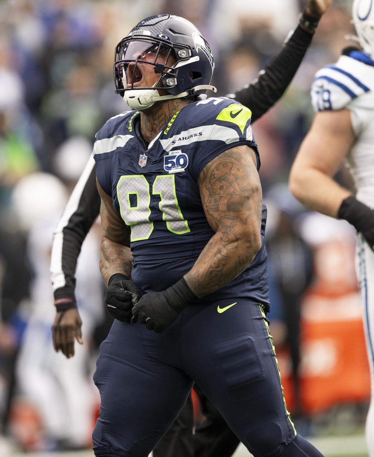 Seattle Seahawks defensive tackle Byron Murphy II (91) reacts to a a tackle against Indianapolis Colts running back Jonathan Taylor (28) during the first quarter of the game at Lumen Field, on Sunday, Dec. 14, 2025, in Seattle.