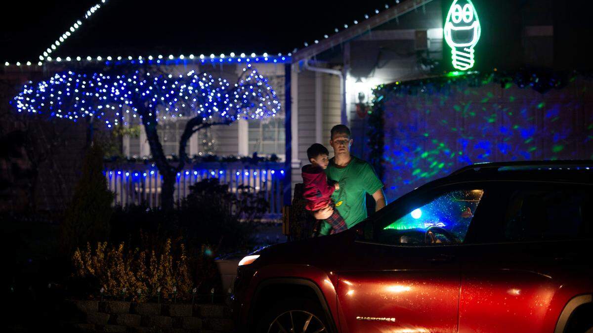 Tad Meyers of Spanaway and his son, Christian, 5, check out the holiday light display at 1713 80th St E in Tacoma, Washington, on Tuesday, Dec. 15, 2020.