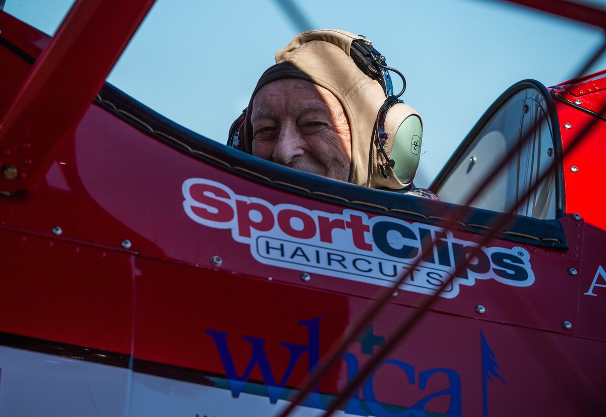Elmer Hart, an Army medic during World War II, flashes a smile from the 1944 Boeing Stearman before his flight.