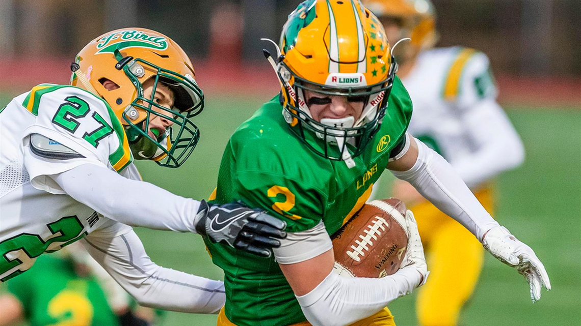 Lynden wide receiver Kobe Elsner (2) evades Tumwater defender Patrick Williams (27) at the line of scrimmage in the second quarter of a Class 2A state quarterfinals game on Saturday Nov. 17, 2018, at Civic Stadium in Bellingham, Wash.