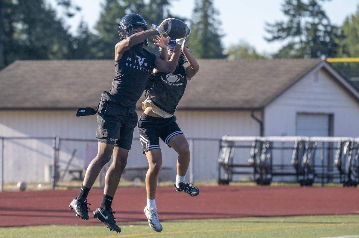Franklin Pierce corners Anthony Lomiga, left, and Jesse Tran jump for control of the ball as the team practices on Wednesday, Aug. 20, 2025, in Tacoma, Wash.