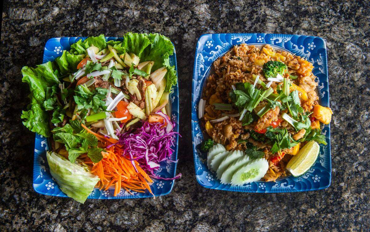 Erawan Sports Bar & Grill in Lakewood serves fresh Thai dishes from an open kitchen, including specialties of beef salad (left) and mango fried rice.