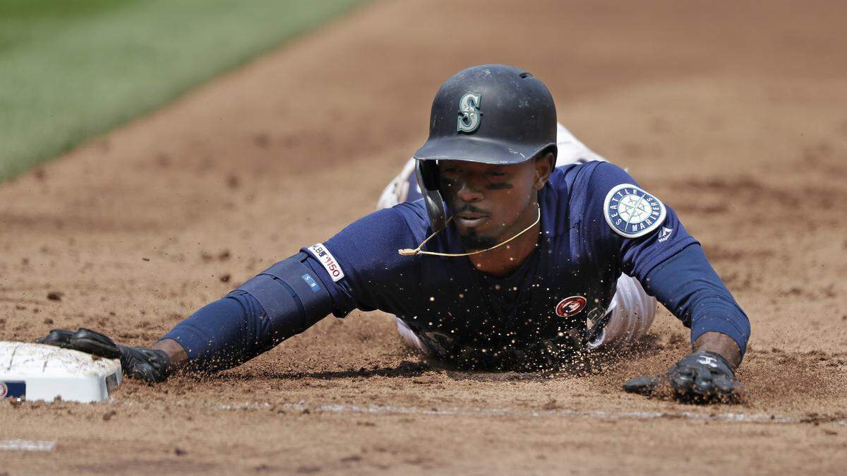 Seattle Mariners’ Dee Gordon dives safely back to first base on a pick-off attempt by the St. Louis Cardinals in a baseball game Thursday, July 4, 2019, in Seattle.