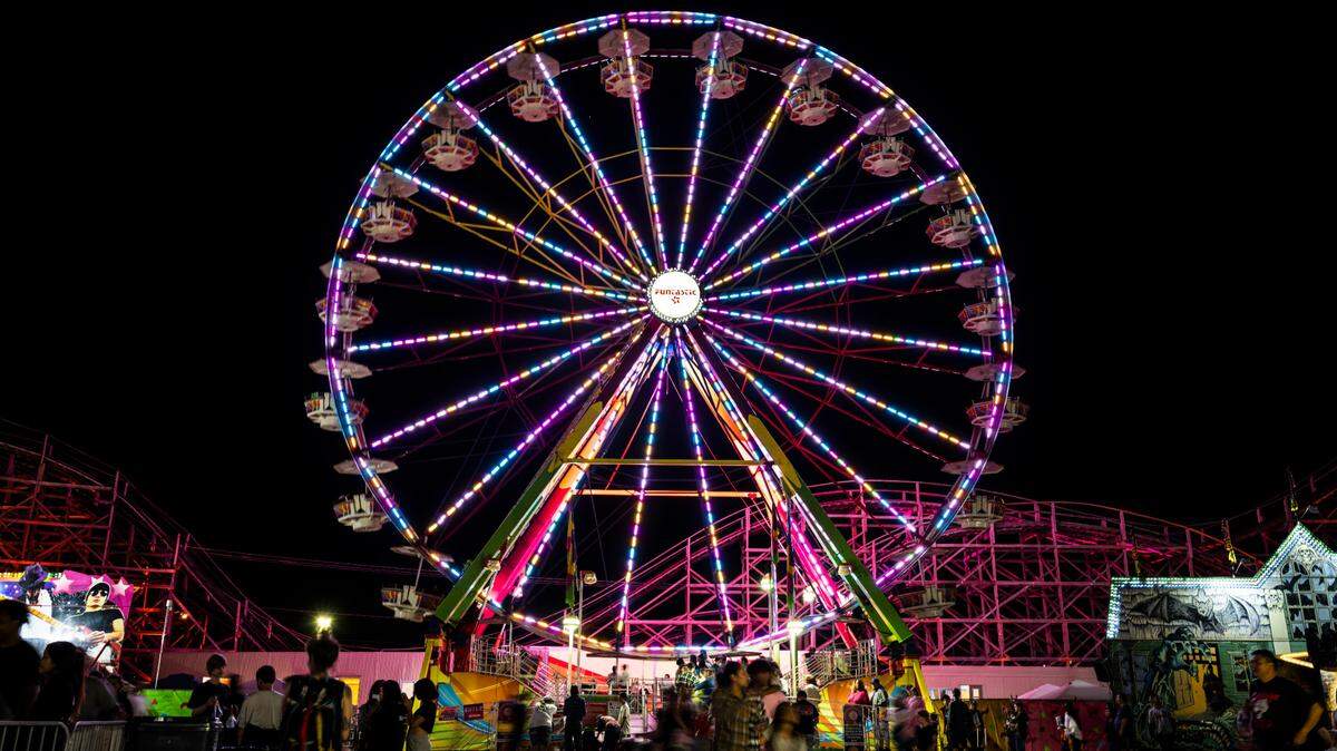 Fair-goers ride on the Grand Ferris Wheel Saturday night at the Washington State Fair in Puyallup, Wash. Sept. 3, 2022.