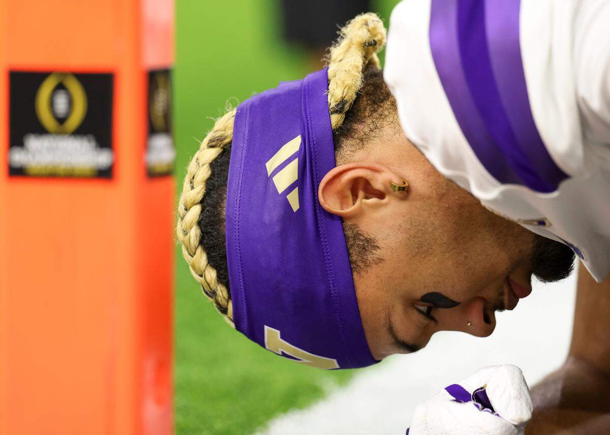 Washington Huskies wide receiver Rome Odunze (1) stretches before the College Football Playoff National Championship game against the Michigan Wolverines at NRG Stadium on Monday, Jan. 8, 2024, in Houston.