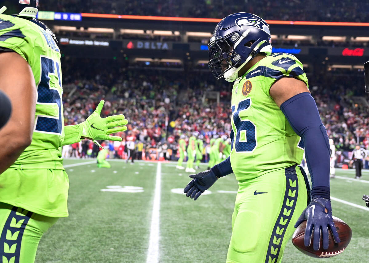 Seattle Seahawks linebacker Jordyn Brooks (56) comes ovff the field after running back an interception on a tip ball during the third quarter of the game against the San Francisco 49ers at Lumen Field, Thursday, Nov. 23, 2023, in Seattle, Wash.