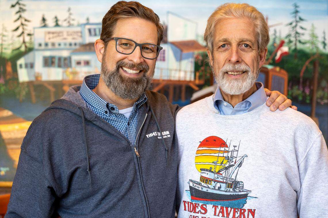 Sporting a throwback sweatshirt, Peter Stanley, right, opened Tides Tavern in 1973. His son, Dylan Stanley, has run the business since 2012.