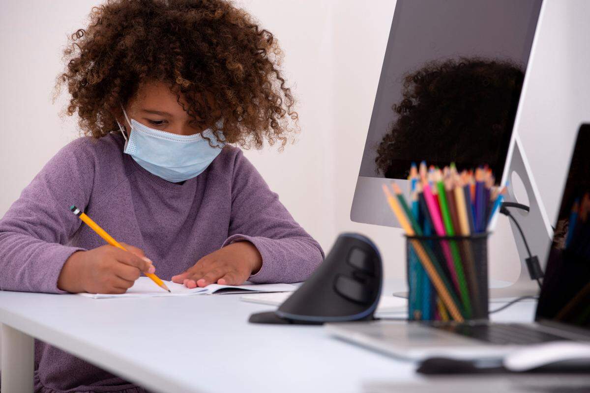 A six-year-old schoolgirl studies remotely far away from her classmates during a global epidemic.