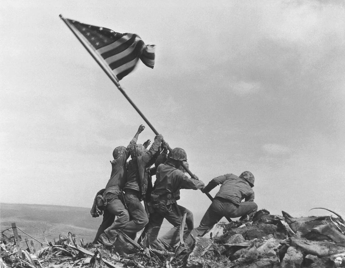 ** FILE ** In a file photo U.S. Marines of the 28th Regiment of the Fifth Division raise the American flag atop Mt. Suribachi, Iwo Jima, on Feb. 23, 1945. Joe Rosenthal, who won a Pulitzer Prize for his immortal image of six World War II servicemen raising an American flag over battle-scarred Iwo Jima, died Sunday. He was 94. (AP Photo/Joe Rosenthal) ORG XMIT: NY110