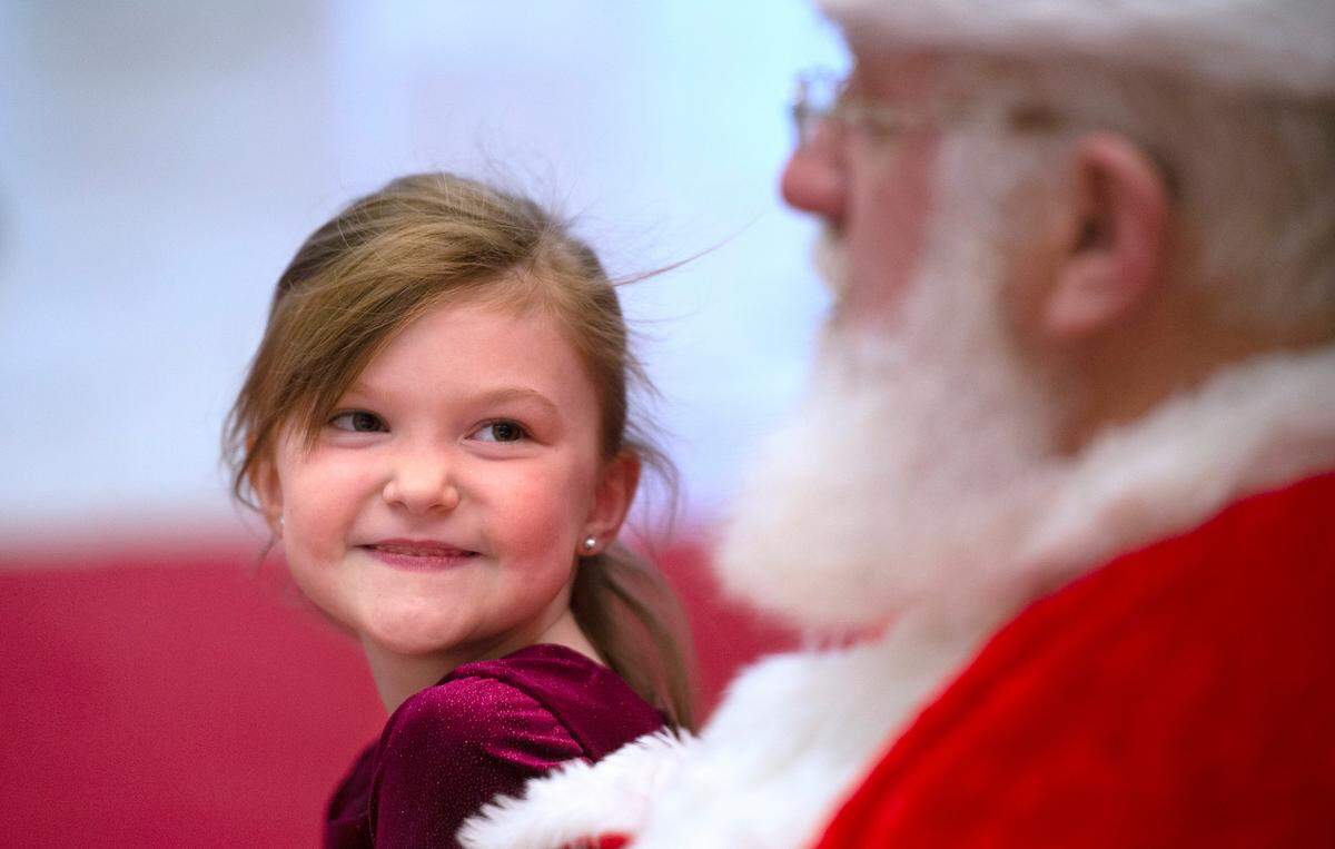 Zoey Kimball, 6, of Eatonville, talks with Santa at the South Hill Mall in Puyallup, Washington, on Wednesday, Nov. 24, 2021.