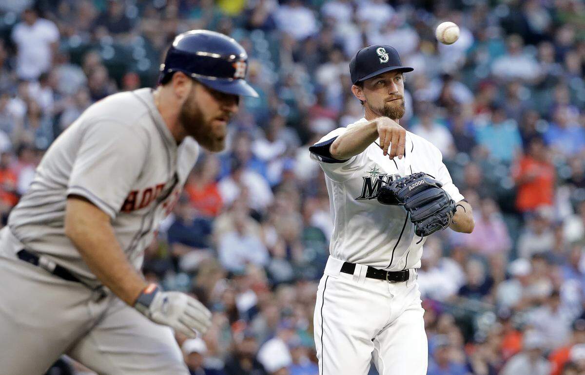 Seattle Mariners starting pitcher Mike Leake throws to first to toss out Houston Astros’ Tyler White on a grounder in the third inning of a baseball game Tuesday, July 31, 2018, in Seattle. (AP Photo/Elaine Thompson)