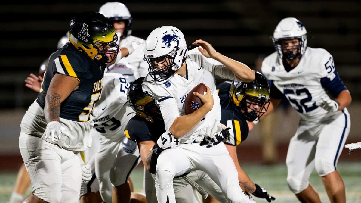Bellarmine Prep quarterback Birk Johnston (4) scrambles against Lincoln defenders during the first half of the game at Lincoln High School, on Friday, Oct. 18, 2024, in Tacoma, Wash.