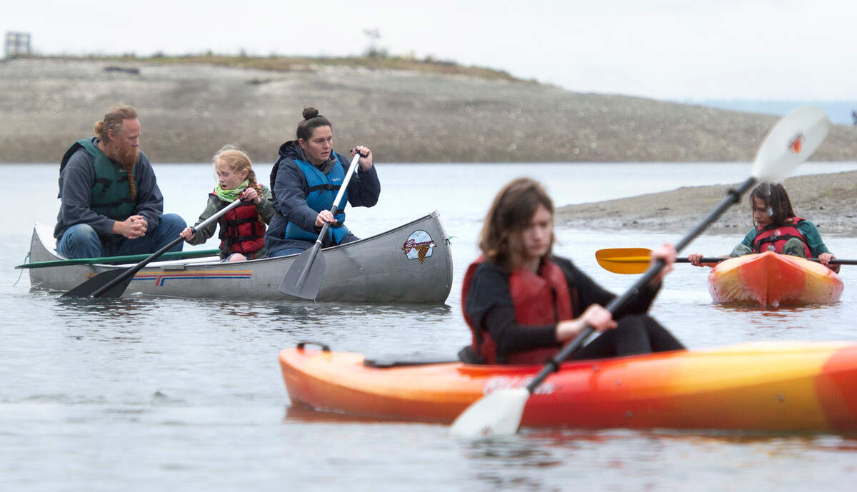 Austin Satterla (from left), Leo O’Callaghan, Kieran O’Callaghan, Molly O’Callaghan and Kieran O’Callaghan paddle through Glen Cove during the Camp Corral military family weekend at YMCA Camp Seymour on the Key Peninsula on Saturday, May 14, 2022.