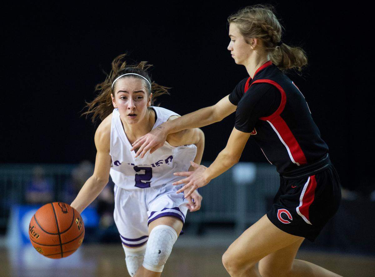 Sumner’s guard Kaylee Cooper (2) drives around Camas’s guard Parker Mairs (5) during the Class 4A quarterfinal state tournament game on Thursday, March 3, 2022, at the Tacoma Dome, in Tacoma, Wash.