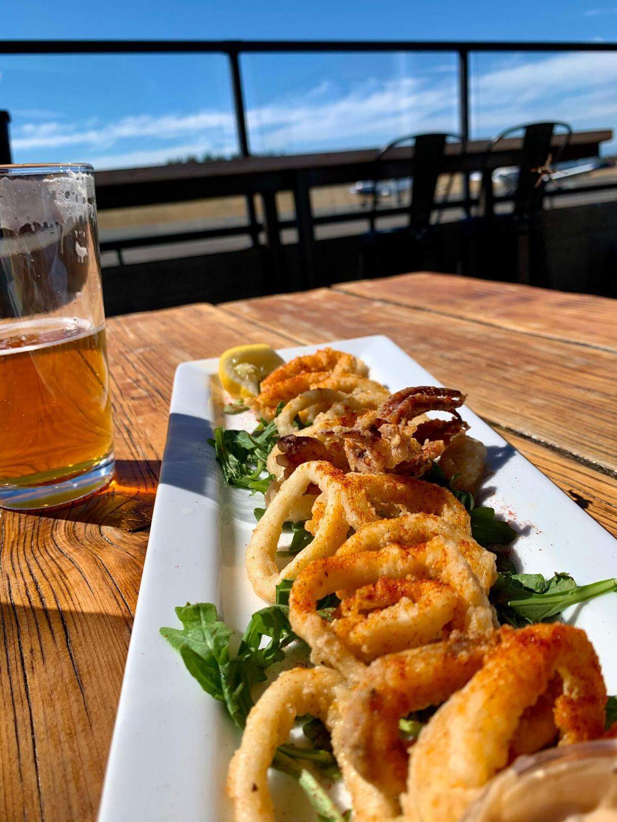 The Hub Gig Harbor boasts three outdoor seating areas, all heated and two in view of the Tacoma Narrows Airport. Local beer and fried calamari with paprika and a spicy aioli can be yours.