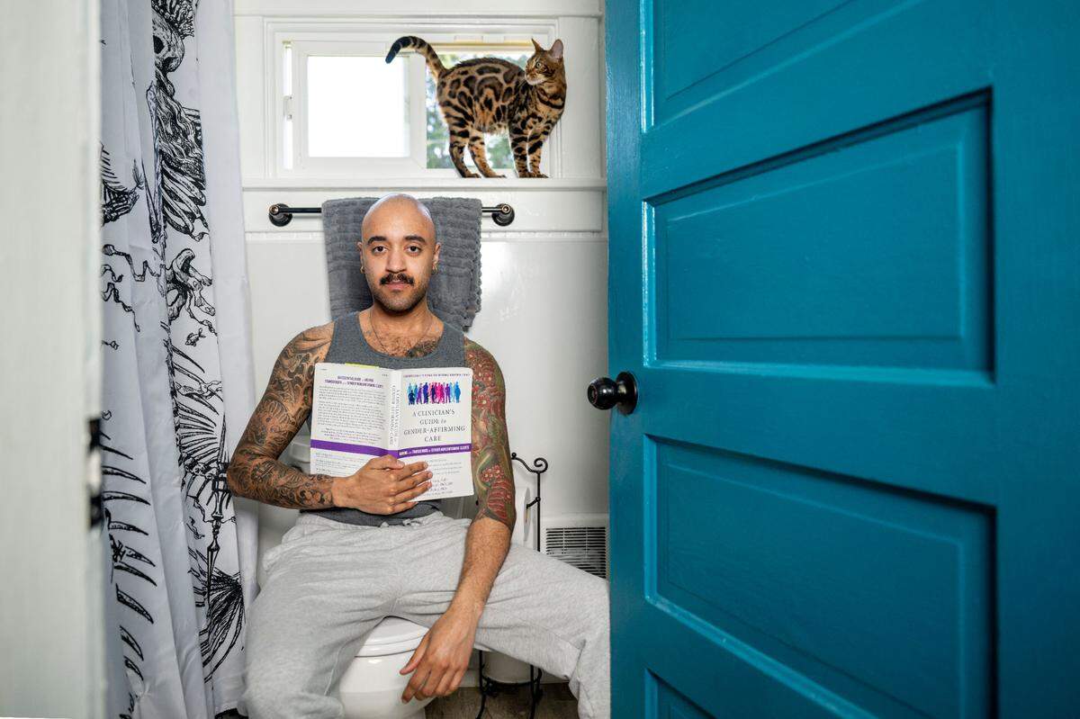 Scott Beck, 26, poses for a portrait in what he says is the most comfortable room in the house for him — the bathroom — on Sunday, July 2, 2023, in Tacoma.
