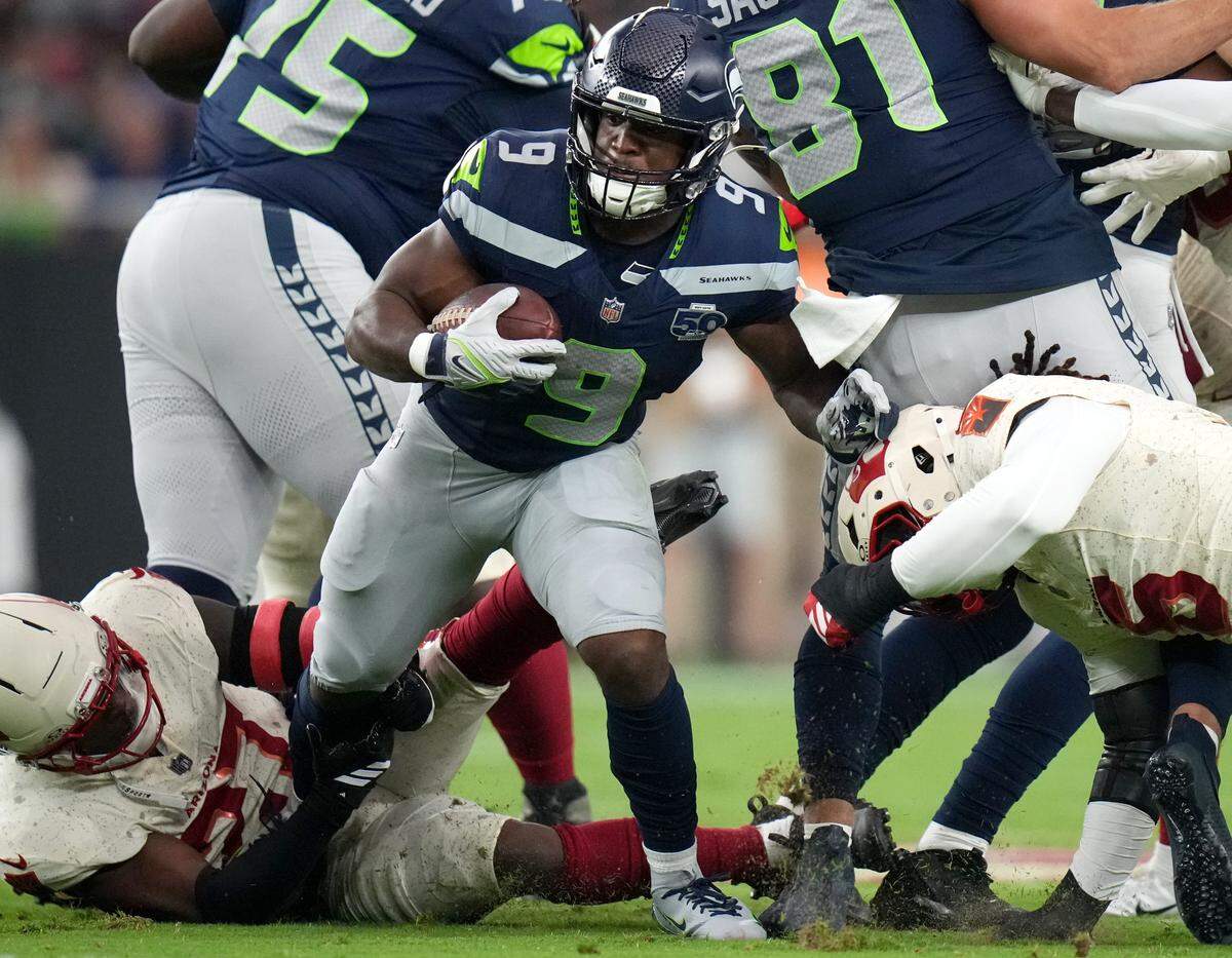 Arizona Cardinals linebacker Akeem Davis-Gaither (27) drags down Seattle Seahawks running back Kenneth Walker III (9) at State Farm Stadium in Glendale, on Sept. 25, 2025.