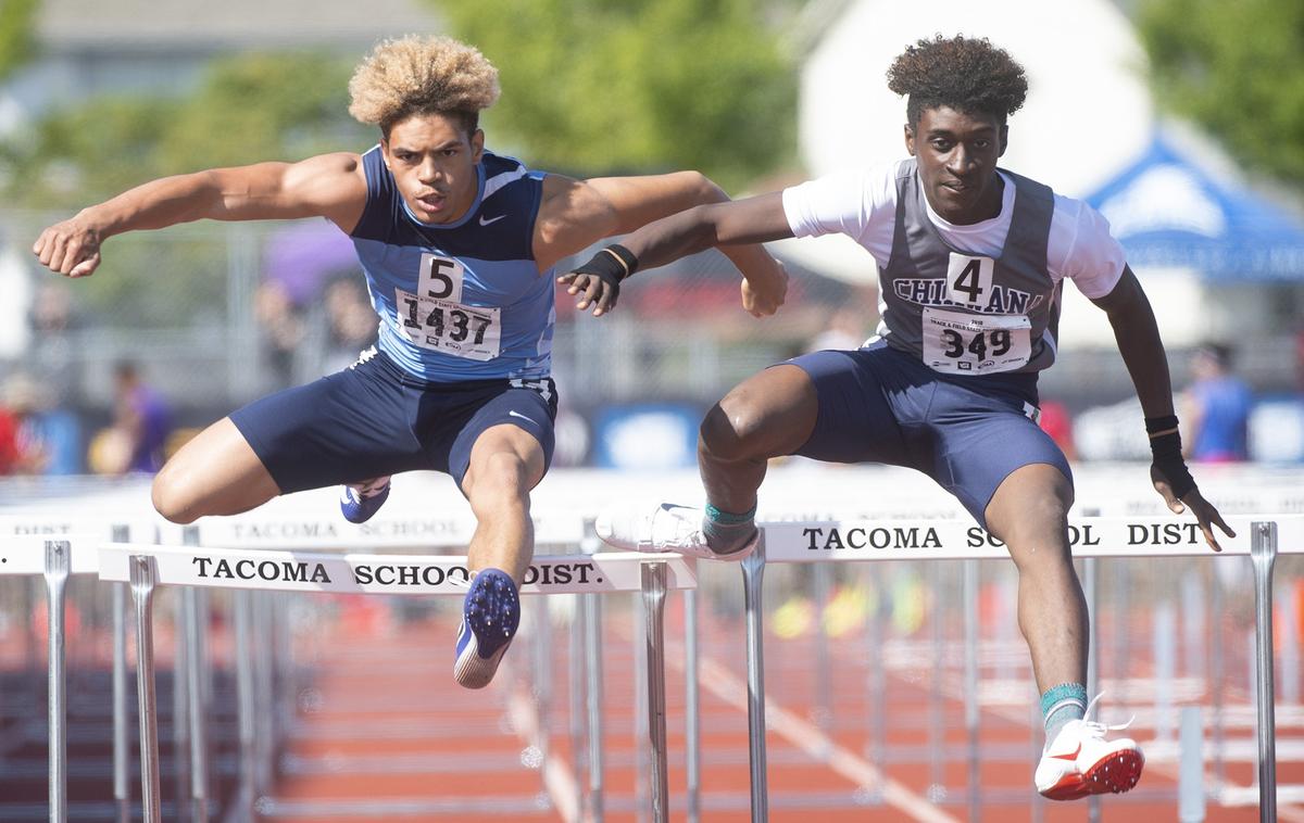 Rogers’ Taylor Murchison (left) battles Chiawana’s Germain Barnes in the 4A boys 110-meter high hurdles in this 2018 file photo.
