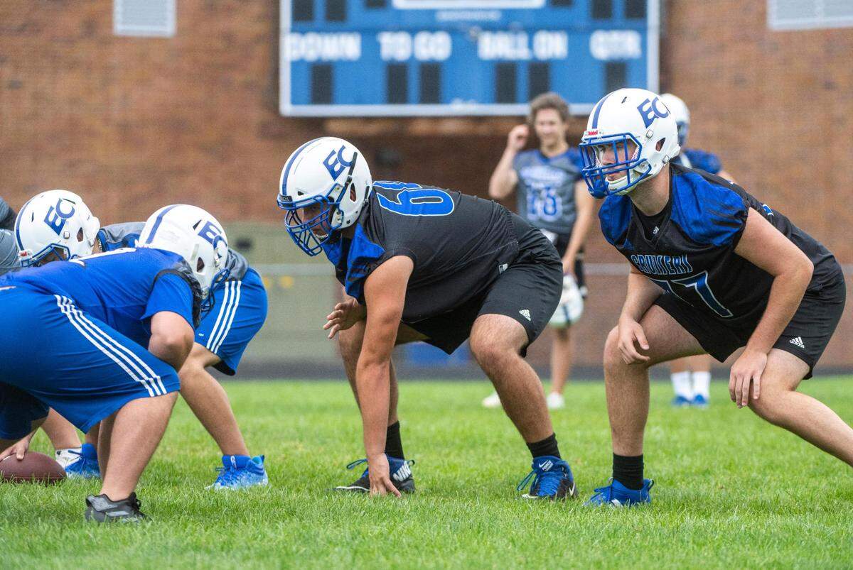 Eatonville Cruisers offensive lineman Tristan Lewis (64) and offensive lineman Kyle Cox (77) prepare to run a play during practice at Eatonville High School in Eatonville Wash. on August 20, 2022.