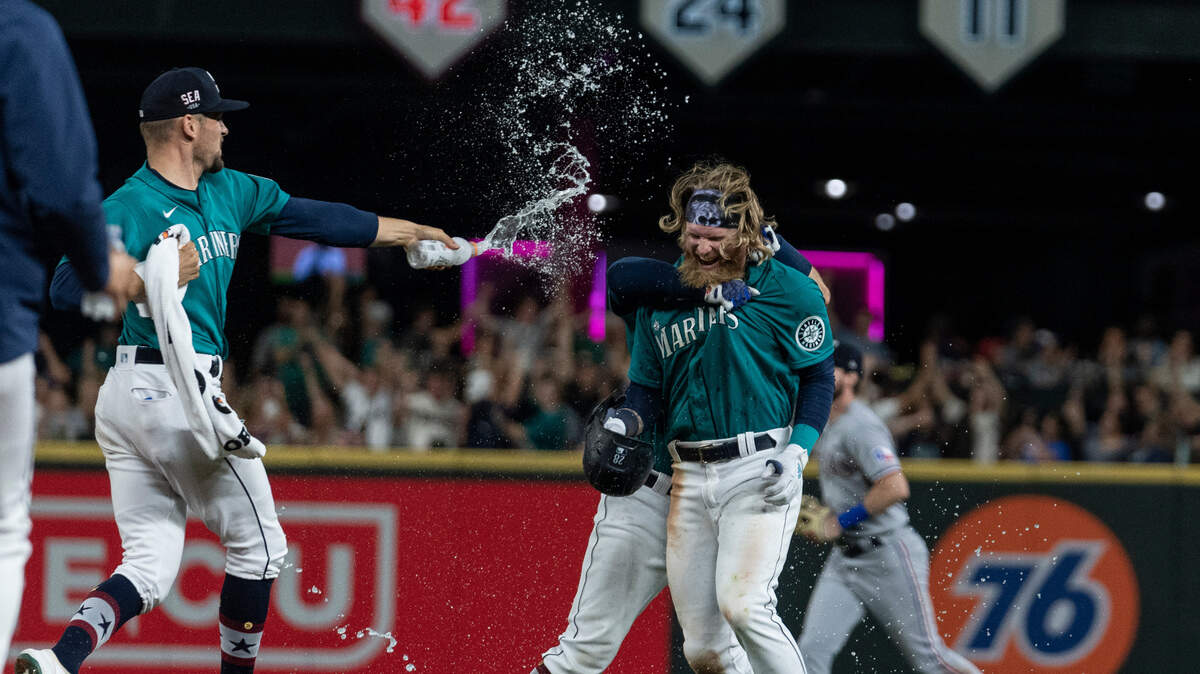 Seattle Mariners’ Jake Fraley is doused by Anthony Misiewicz after a baseball game against the Texas Rangers, Friday, July 2, 2021, in Seattle. The Mariners won 5-4 in 10 innings. (AP Photo/Stephen Brashear)