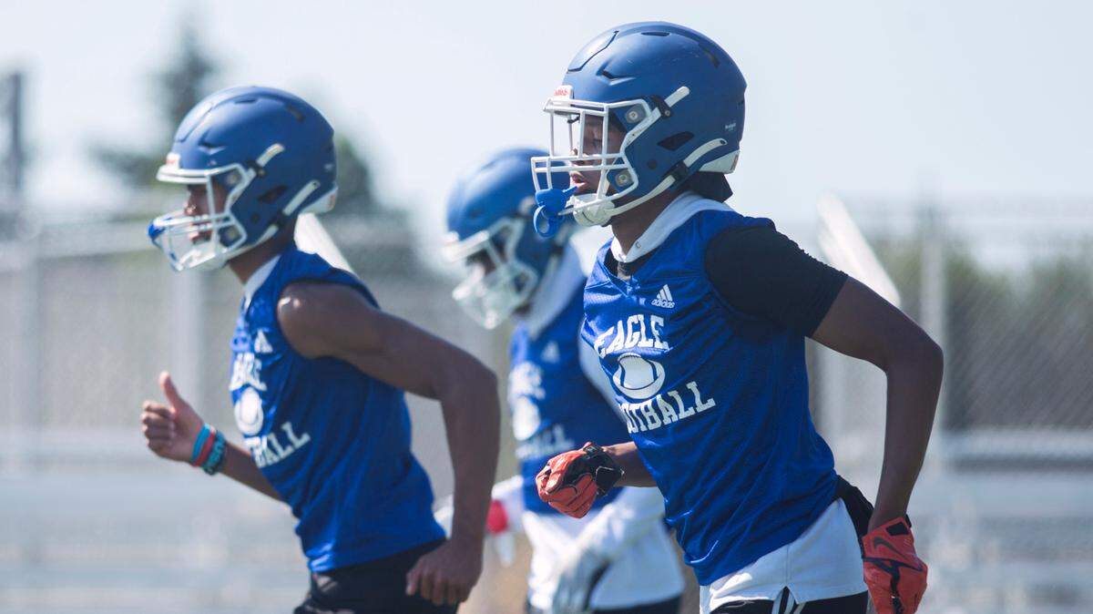 Federal Way High School defensive back Andre Piper-Jordan Jr. runs through a drill with teammates on the first day of practice on Wednesday, Aug. 17, 2022 in Federal Way, Wash.