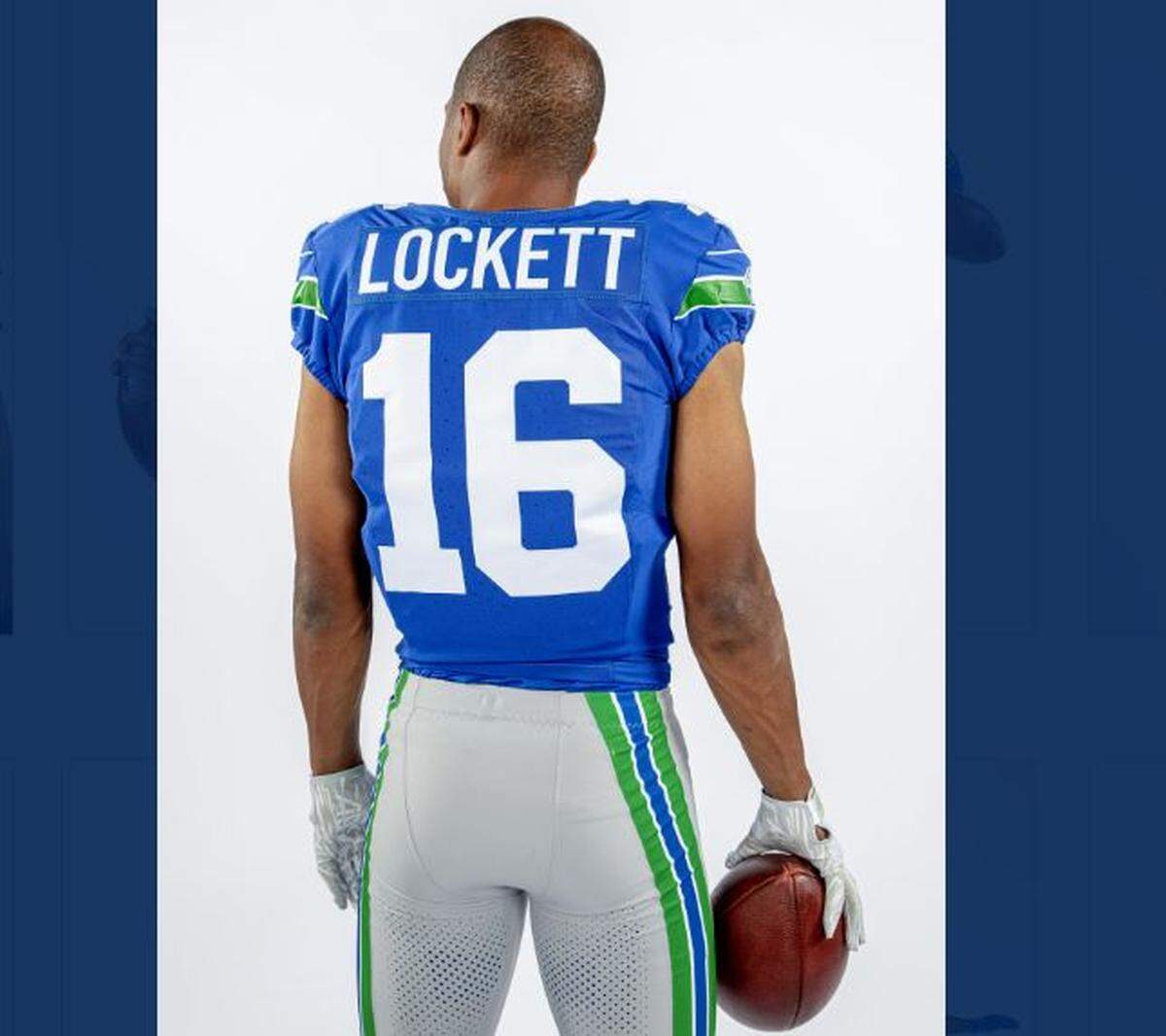 Wide receiver Tyler Lockett displays the throwback uniforms from the 1990s the Seahawks will wear during the 2023 season, for a home game Oct. 29, 2023, against the Cleveland Browns.