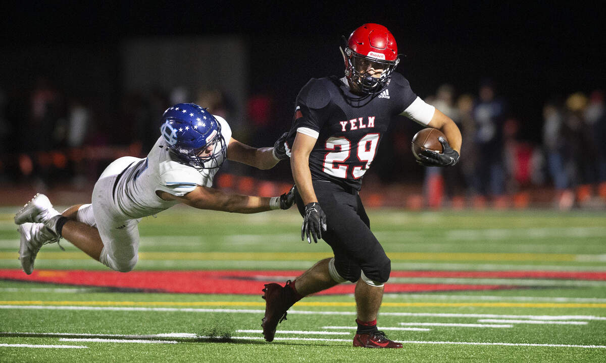 Yelm running back Carson Amendt hauls Gig Harbor linebacker Jake Jennings downfield during Friday night’s 3A SSC football game at Yelm High School on Sept. 27, 2019.