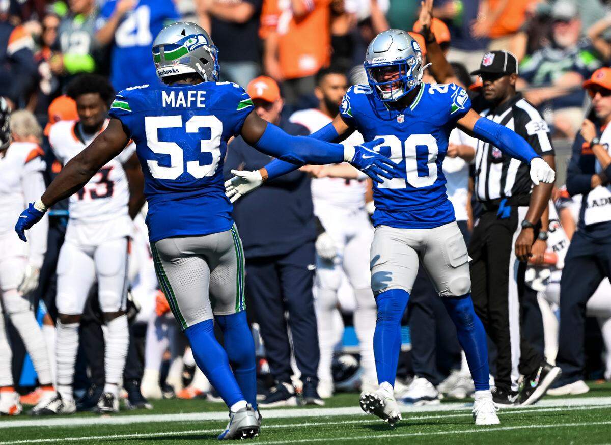 Seattle Seahawks cornerback Artie Burns (23) and safety Julian Love (20) react to a defensive stop against the Denver Broncos during the third quarter of the game at Lumen Field, on Sunday, Sept. 8, 2024, in Seattle, Wash.