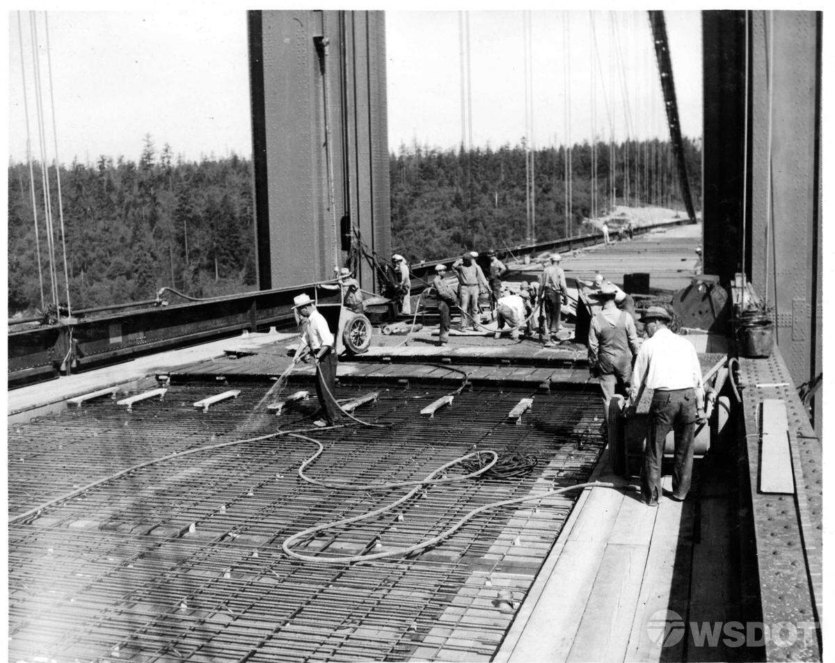 This photo shows construction of the 1940 Tacoma Narrows Bridge. Crews used large wheel barrows to pour the bridge deck concrete.