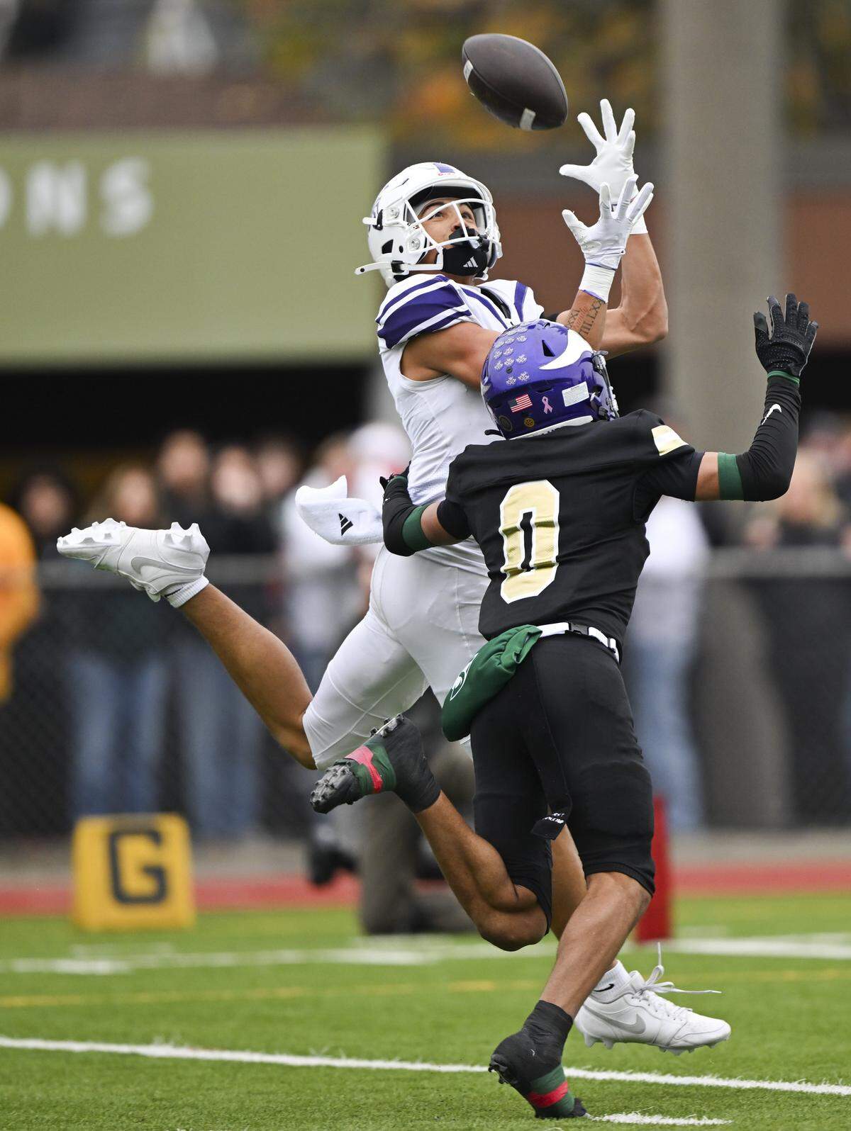 Sumner wide receiver Braylan Pope (0) catches a touchdown reception against Puyallup safety Jasiah Denmark (0) during the first half of the 4A state semifinal game at Sparks Stadium, on Saturday, Nov. 29, 2025 in Puyallup, Wash.