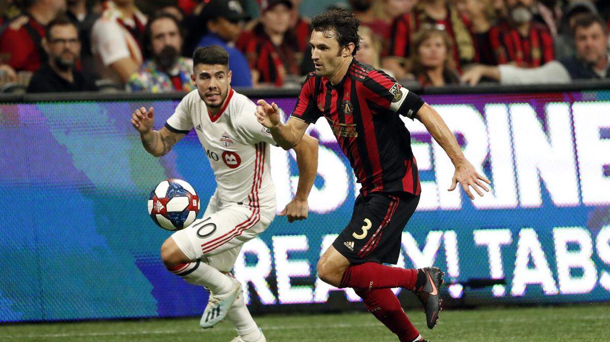 Toronto FC midfielder Alejandro Pozuelo (10) and Atlanta United defender Michael Parkhurst (3) compete for the ball during the first half of the MLS soccer Eastern Conference final Wednesday, Oct. 30, 2019 in Atlanta. Toronto won 2-1.