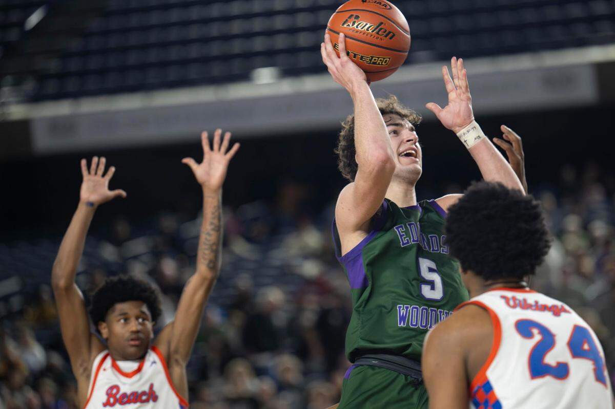 Edmonds-Woodway guard Cameron Hiatt (5) attempts a shot as Rainier Beach forward Marques Ili-Meneese (24) defends during the second quarter of the Class 3A state championship game at the Tacoma Dome on Saturday, March 8, 2025, in Tacoma, Wash.