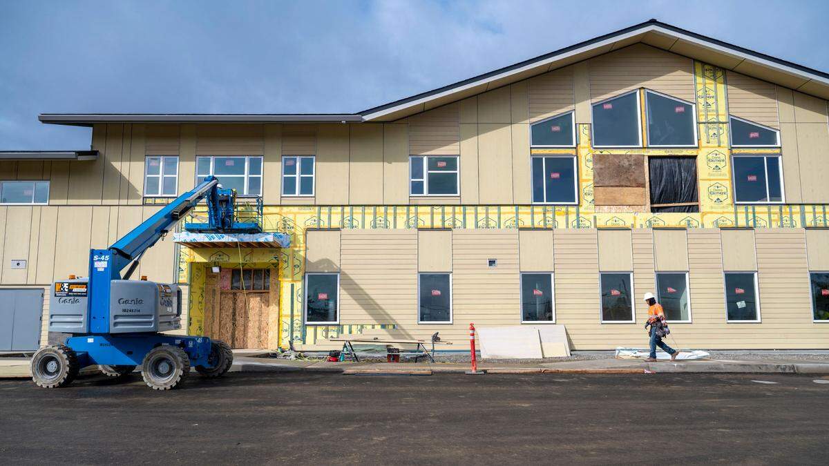 A workers walks past the front of the new Fawcett Elementary School on Friday, March 3, 2023, in Tacoma.
