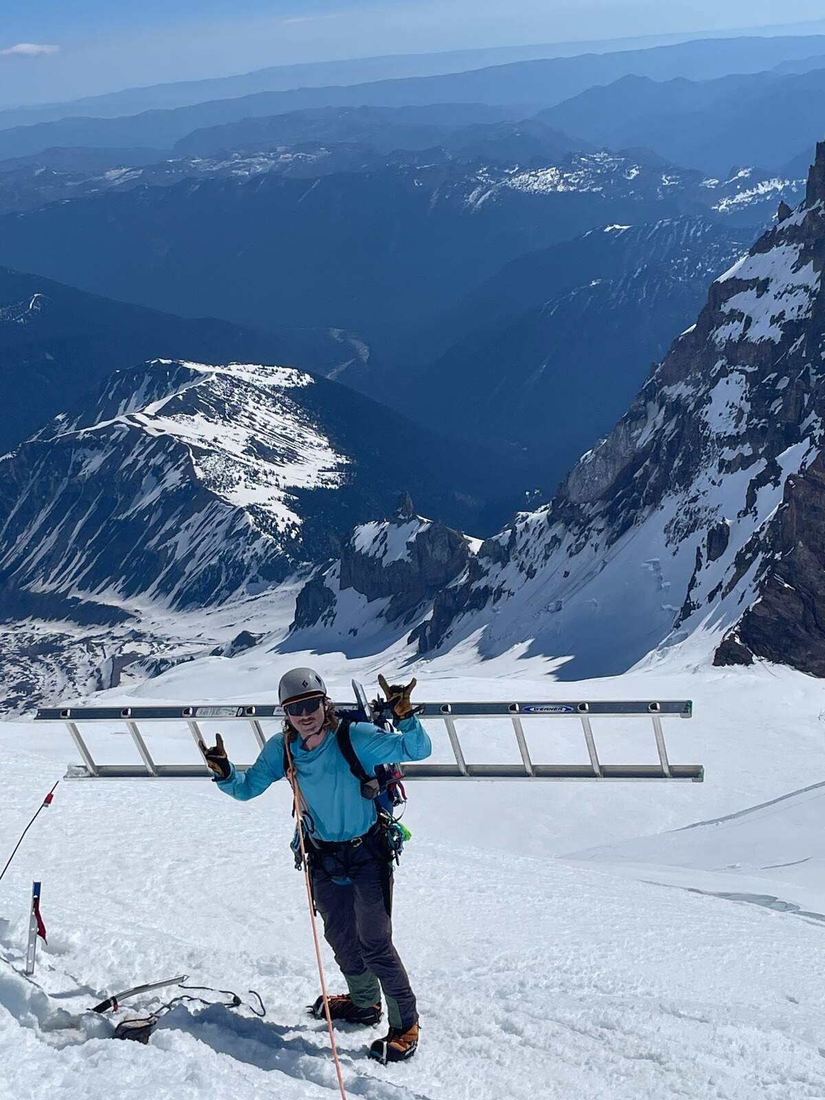 An RMI guide quite literally carrying a ladder up Mount Rainier on his back. A regular job for a guide who helps maintain its most popular routes.
