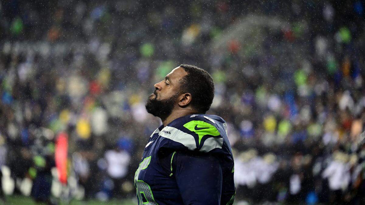 Seattle Seahawks offensive tackle Duane Brown (76) grimaces while rain begins to pour down after the Seahawks lost to the Saints, 13-10, in an NFL game on Monday night at Lumen Field in Seattle.