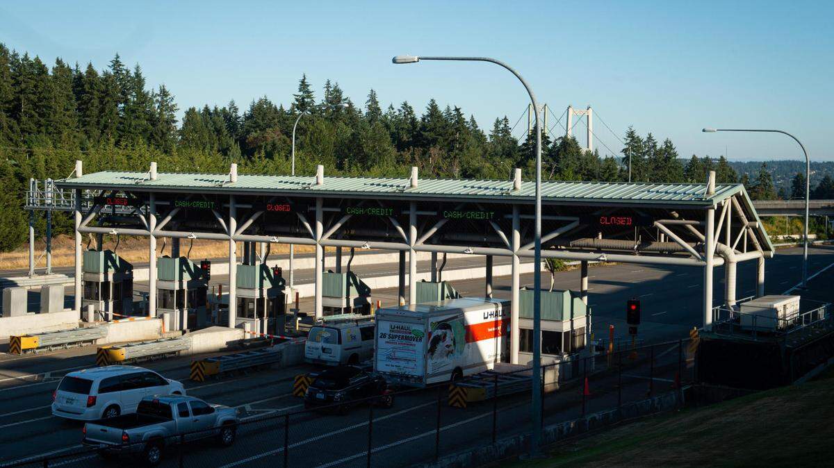 Cars pull up to the toll booths near the Tacoma Narrows Bridge in Gig Harbor, Wash., on Monday, July 20, 2020.