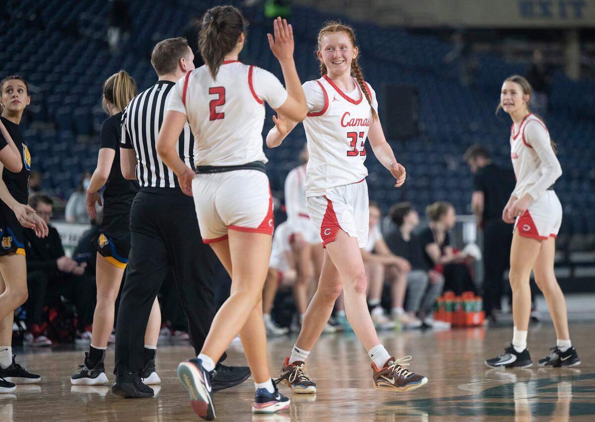 Camas’ Addison Harris (facing) is congratulated by teammate Kendall Mairs after scoring during their state semifinal game against the Tahoma Bears at the WIAA state basketball tournament in the Tacoma Dome in Tacoma, Washington, on Friday, March 3, 2023. Camas won the game, 57-47.