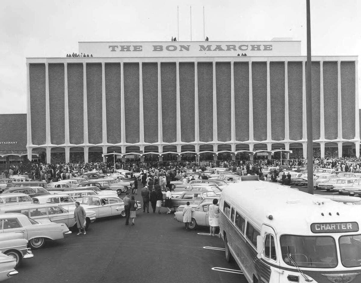 Grand opening of Bon Marche at the Tacoma Mall. 150,000 people attended the official opening on August 3, 1964, of the first occupant of the Tacoma Mall Shopping Center. The parking lot is crammed full of cars, including a charter bus.