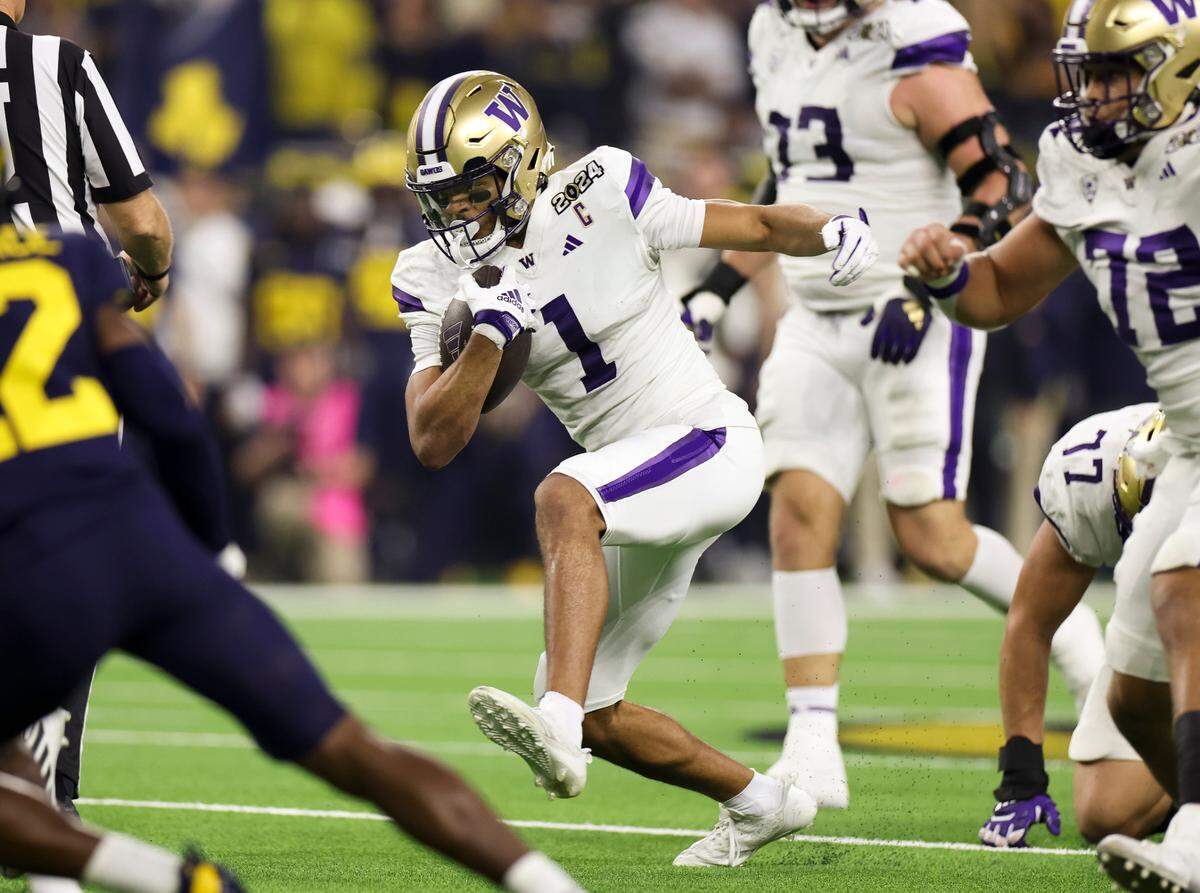 Washington Huskies wide receiver Rome Odunze (1) carries the ball after the catch during the second quarter of the College Football Playoff National Championship game against the Michigan Wolverines at NRG Stadium on Monday, Jan. 8, 2024, in Houston.